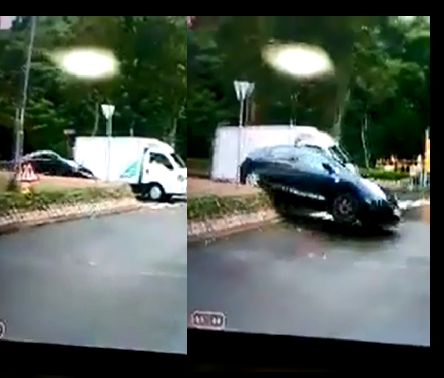 私家車為越過前方停在迴旋處前的貨車,竟高速剷上石壆。影片截圖