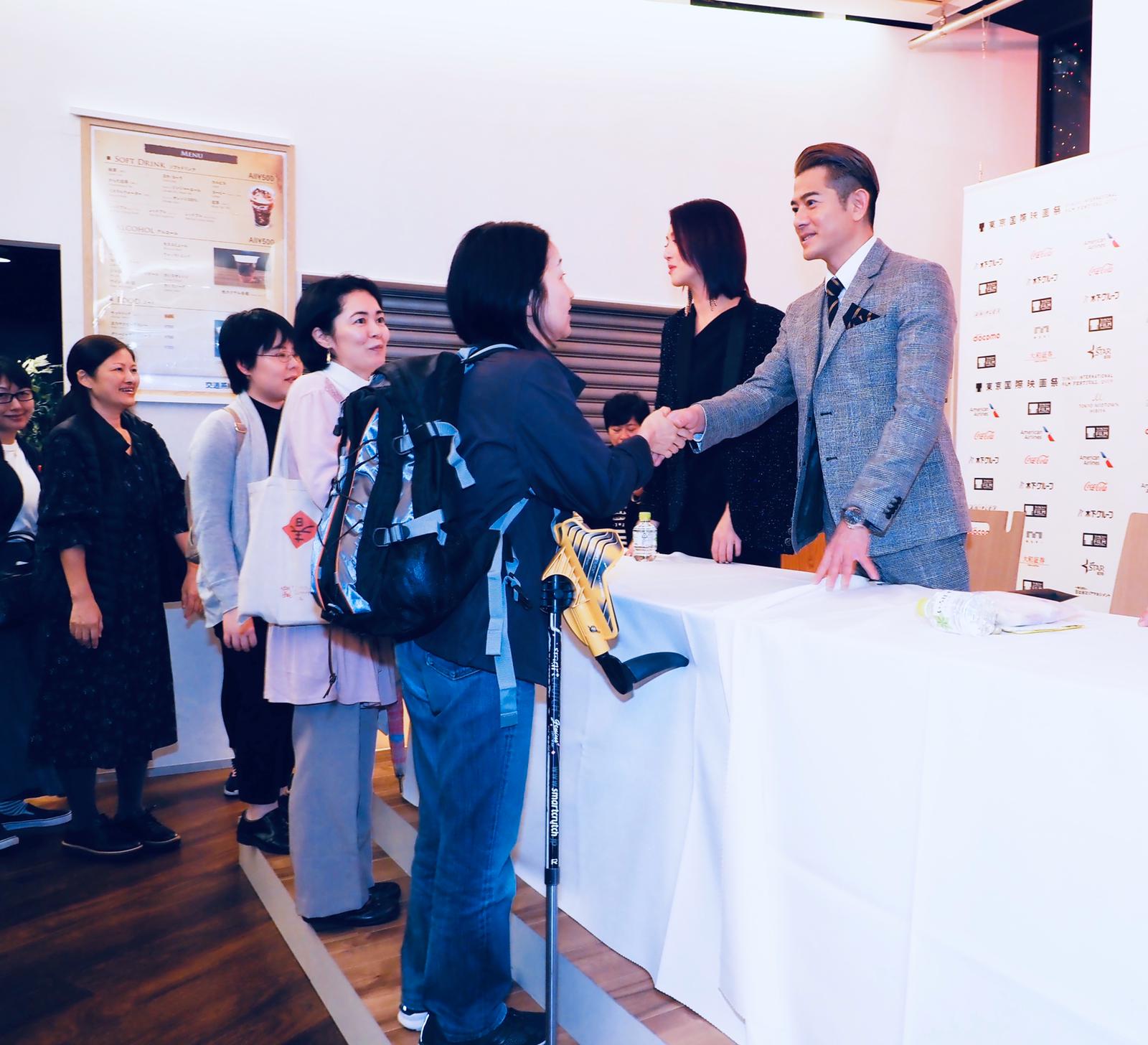 兩人與粉絲握手。